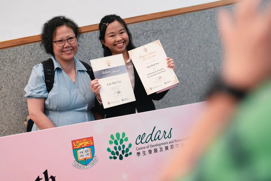 Student awardees celebrate their achievements with their loved ones, with joy and pride.