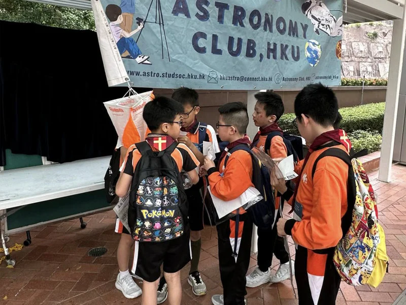 Scout teams from different groups searched for control points on the campus of the University of Hong Kong to complete the weather orienteering competition.   