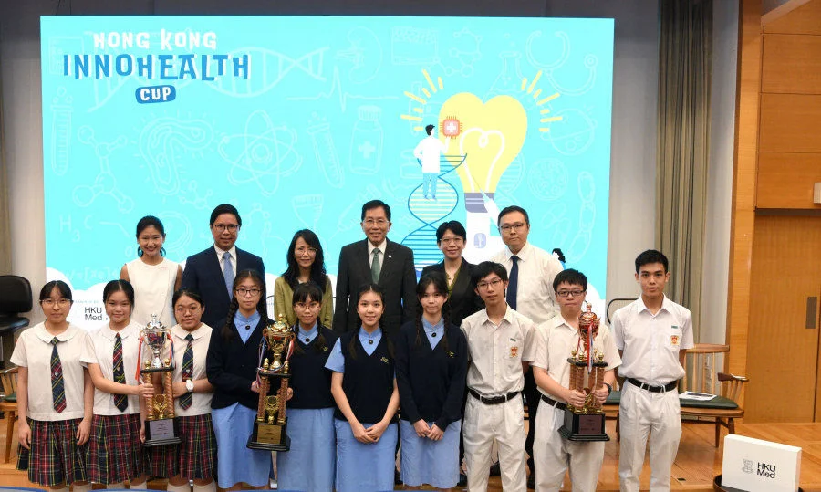 The award-winning teams and secondary school teachers, pose for a photo with representatives from the co-organisers, including competition convenor Professor Chan Ying-shing (back row, third from right), Principal Lee Yi-ying, Chairman of the Hong Kong Subsidized Secondary Schools Council (back row, third from left), and two representatives from the School of Biomedical Sciences at HKUMed, Professor Joshua Ho Wing-kei (back row, second from left) and Professor Cora Lai Sau-wan (back row, second from right).  